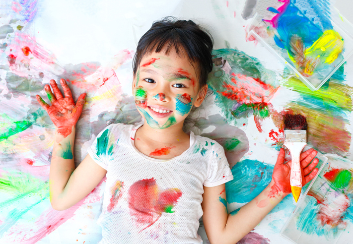Little girl naughty with colorful paint